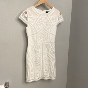 White embroidered bodycon dress.